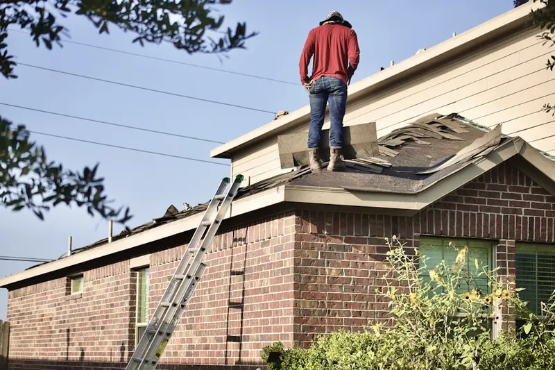 Professional roofer working on a residential roof in North Fair Oaks